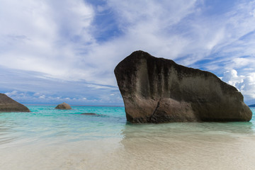 Landscape of the sea with rocks. Clear blue water in the bay. Sea view from tropical beach with sunny sky. 