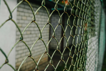 Naklejka premium A close up of a green chain link fence on an angle.
