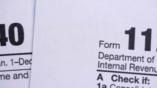 Tax Forms 1040, 1120, 1120-w, 1065, W-4. Extreme close up.
