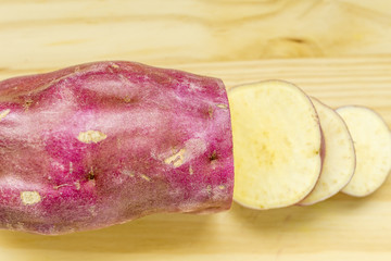 Slicing sweet potatoes over wood