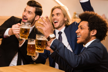 businessmen drinking beer in bar