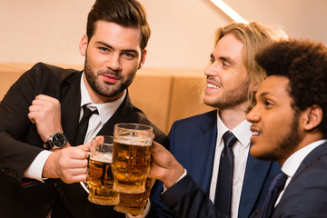 businessmen drinking beer in bar