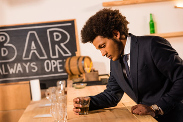 african american businessman drinking whisky