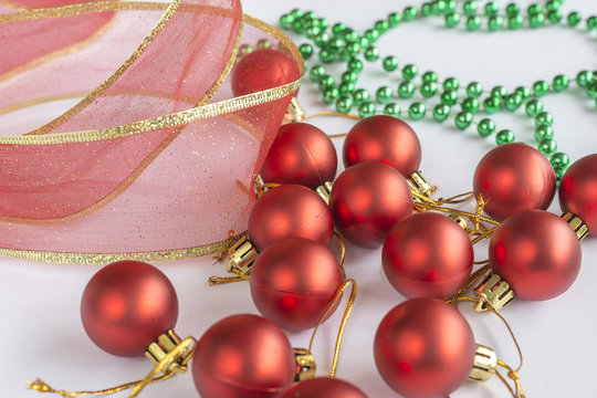 Christmas ornaments, red and gren balls and a red and gold ribbon