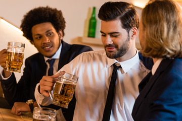 businessmen drinking beer in bar