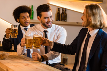 businessmen drinking beer in bar
