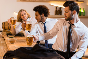 businessmen drinking beer in bar