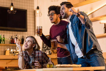 friends with pizza and beer in bar