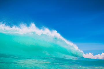 Blue ocean wave at tropical beach. Clear wave in tropics and blue sky