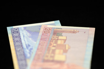 Banknotes of ten and twenty Lithuanian litas on a dark background
