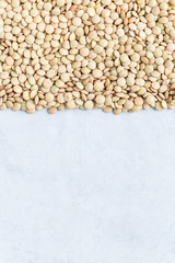 Uncooked dry green lentils, vertical, copy space, top view