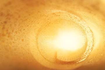 Golden glitter texture. Textile roll with light inside. Design concept. Abstract background. Blured...