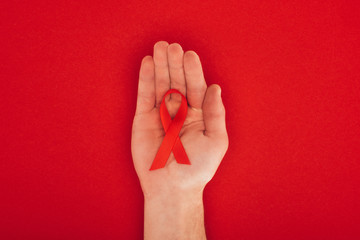 hand with aids ribbon