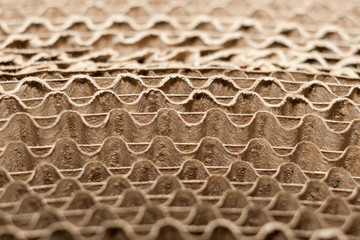 Wavy edges of layers of corrugated cardboard. Selective focus.