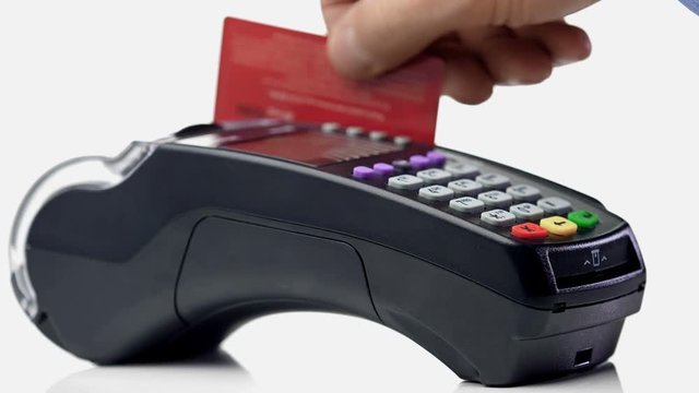 Credit card payment terminal, swiping for sale transaction. Close-up view.
