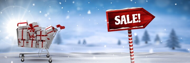 Sale text and gifts in trolley with Wooden signpost in Christmas