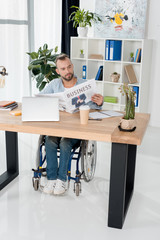 disabled man reading newspaper