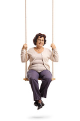 Elderly woman sitting on a wooden swing