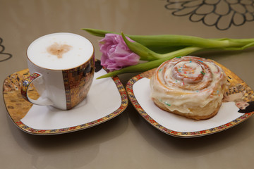 Coffee, bun and flower