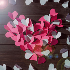 Cut out from paper red hearts laid out in the form of a big heart top view
