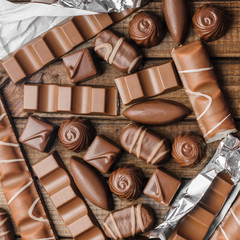 Background of chocolates, bars and sweets, free space for text, close up
