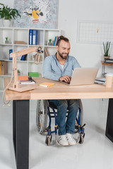 businessman on wheelchair working with laptop