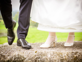 Bride and groom show their shoes
