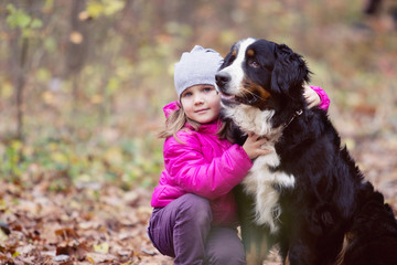 child hugs dog