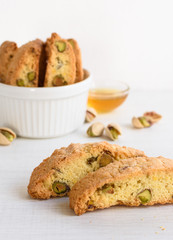 Homemade biscotti cantucci, Italian traditional sweets biscuits (cookies) from tuscany. Biscuits are put in a glass jar. Close-up on two biscuits in the foreground.