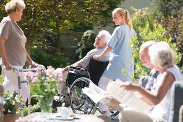 Nurse supporting senior man