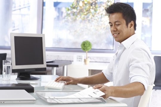 Young businessman working in bright office