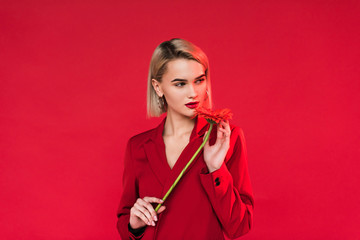 girl in red suit with flower