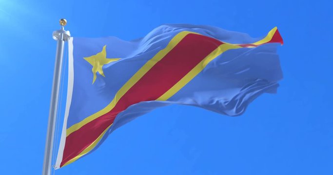 Flag of the Democratic Republic of the Congo waving at wind with blue sky, loop