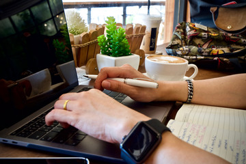 Woman using laptop at cafe