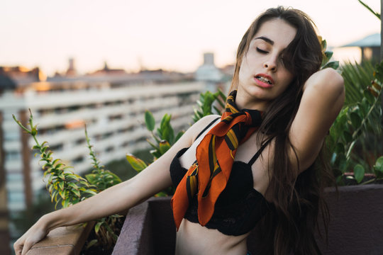 Sexual model posing on balcony