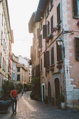 Old European street with architecture in italy in the evening on the shores of Lake Lago di garda