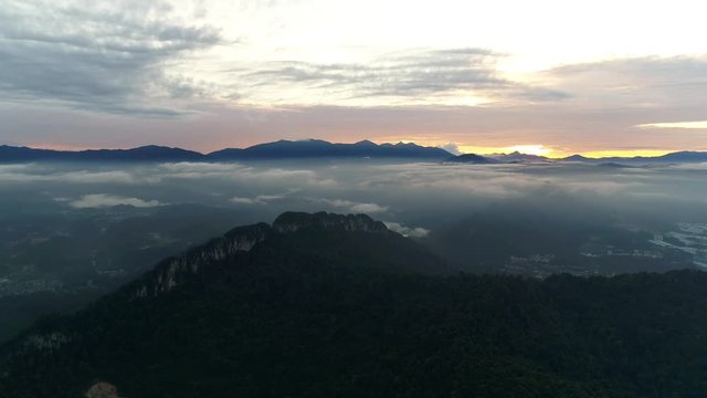 Aerial view. Approaching highland peak with foggy atmosphere at the background.