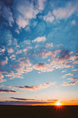 Sunset Sunrise Over Field Or Meadow. Bright Dramatic Sky And Dark