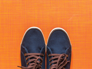 Blue sneakers on orange background