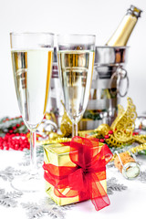 glasses of champagne and Christmas ornaments on white background
