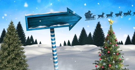 Wooden signpost in Christmas Winter landscape with Christmas