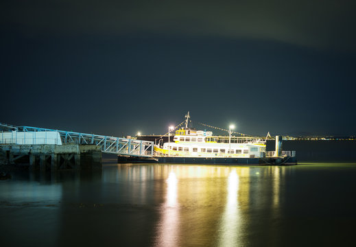 Moored ship at the pier at night.