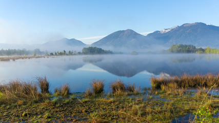 Epic landscape photo with morning fog in a moorland area in the mountains of the Bavarian Alps