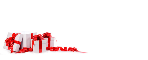 three christmas gift white box with red bow and ribbon on a white background and empty space for text