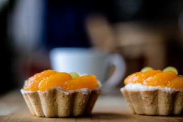 Tasty muffin with fruit on a wooden table. Hot tasty coffee in a cup.