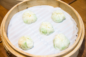 Xiaolongbao, Chinese steamed bun in small bamboo basket.