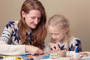 Mom and daughter make a New Year's card
