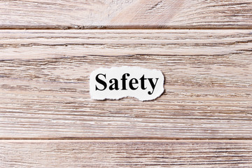 safety of the word on paper. concept. Words of safety on a wooden background