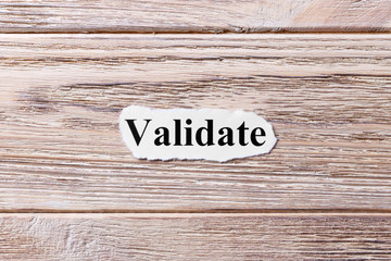 VALIDATE of the word on paper. concept. Words of VALIDATE on a wooden background