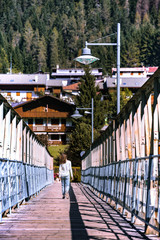 teen girl walking on a bridge